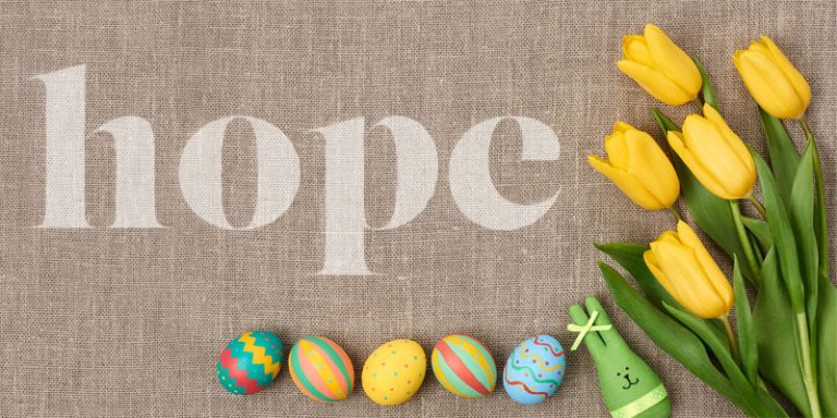 easter eggs and flowers with the word hope on hessian