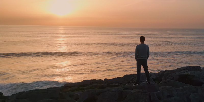 silhouette of man looking into the sunset