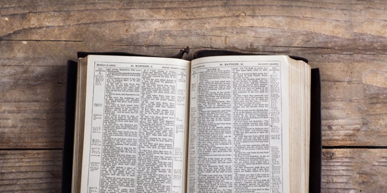 bible open on wooden table