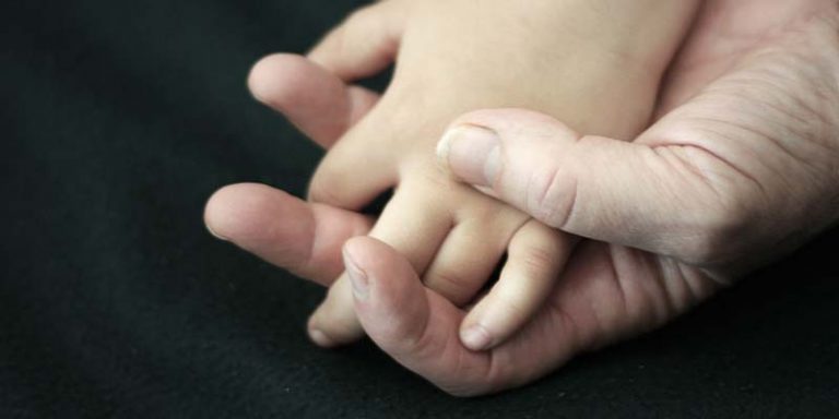 childs hand in fathers hand